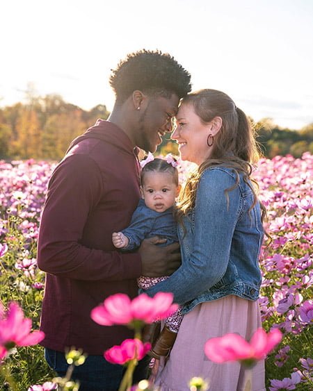 Photography by photographer Emily Fagin. Specializing in newborn photography, themed photoshoots, cake smashes, engagements, and more. Serving Greensboro, NC and the Triad area. Spring and flower themed family photo.