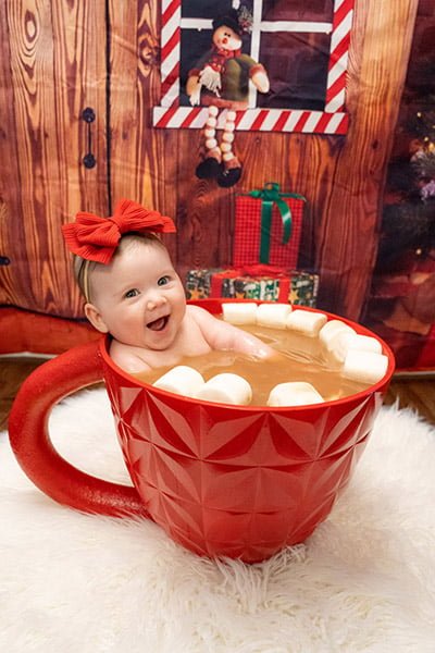 Photography by photographer Emily Fagin. Specializing in newborn photography, themed photoshoots, cake smashes, engagements, and more. Serving Greensboro, NC and the Triad area. Christmas and winter themed photoshoot with hot cocoa.