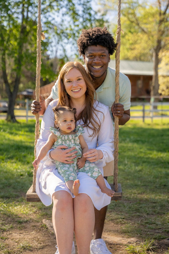 Family pictures in a spring and summer themed photoshoot on an outdoor wooden swing