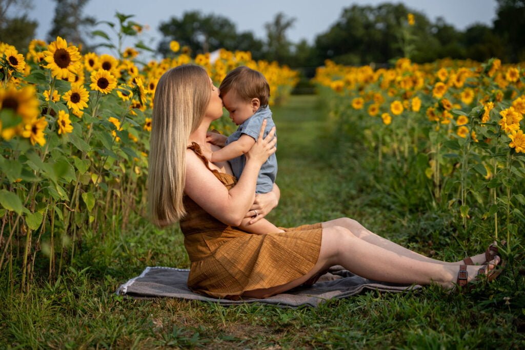 Spring and Summer Themed Photoshoot Mini Session Ideas with mother and her infant baby in a sunflower field