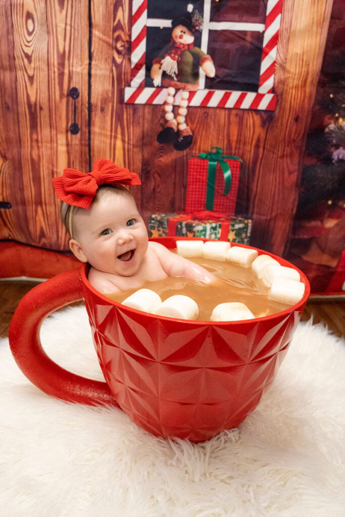 Photography themed mini sessions ideas with a baby smiling in a giant mug or cup of hot cocoa