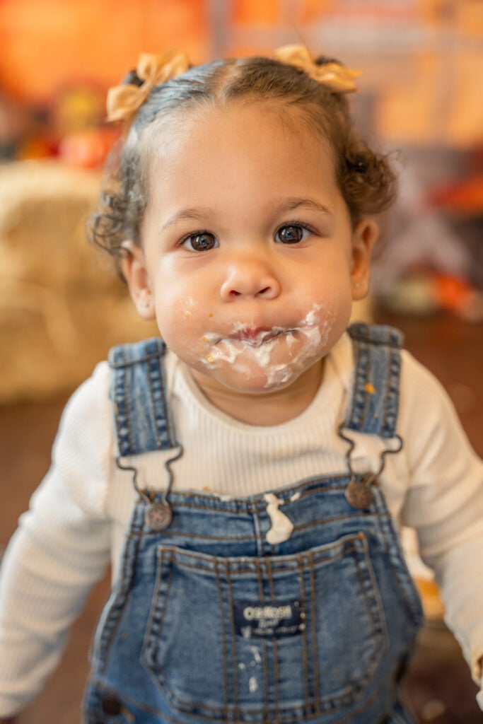 Closeup of fun season mini session themed photoshoot with a pumpkin pie smash